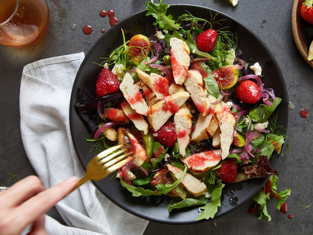 Cultivated chicken cut on a salad from above